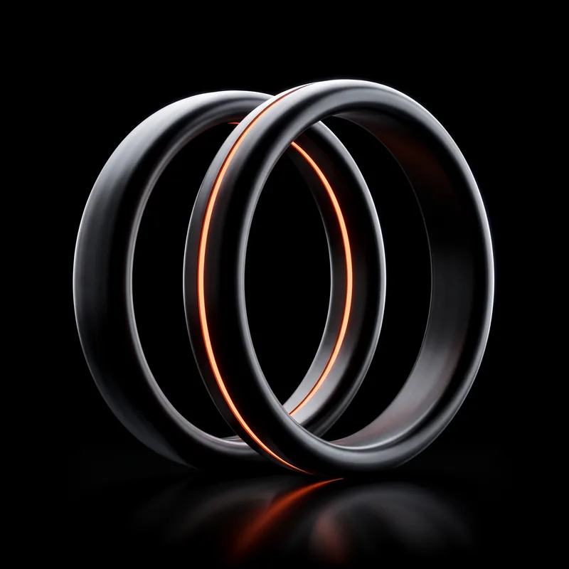 Two graphite rings side by side, one lit orange on the inside