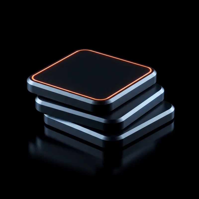 Three graphite tiles in a sorted stack, the top one edged in orange light