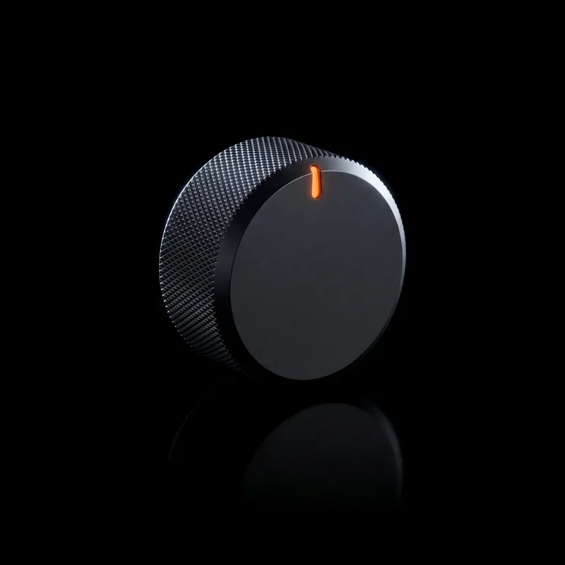 A knurled graphite dial with one orange notch